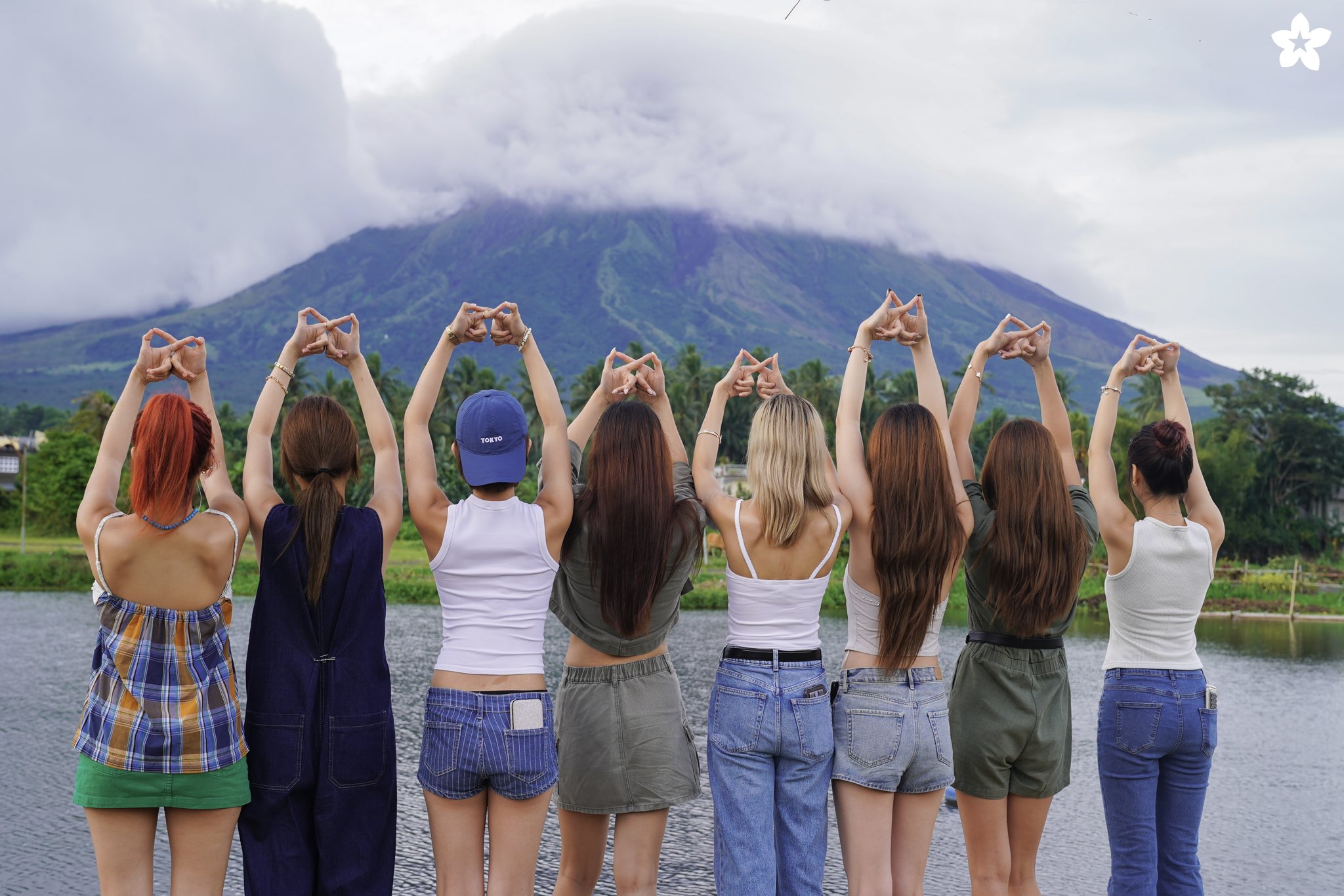 BINI members posing on a mountain ridge