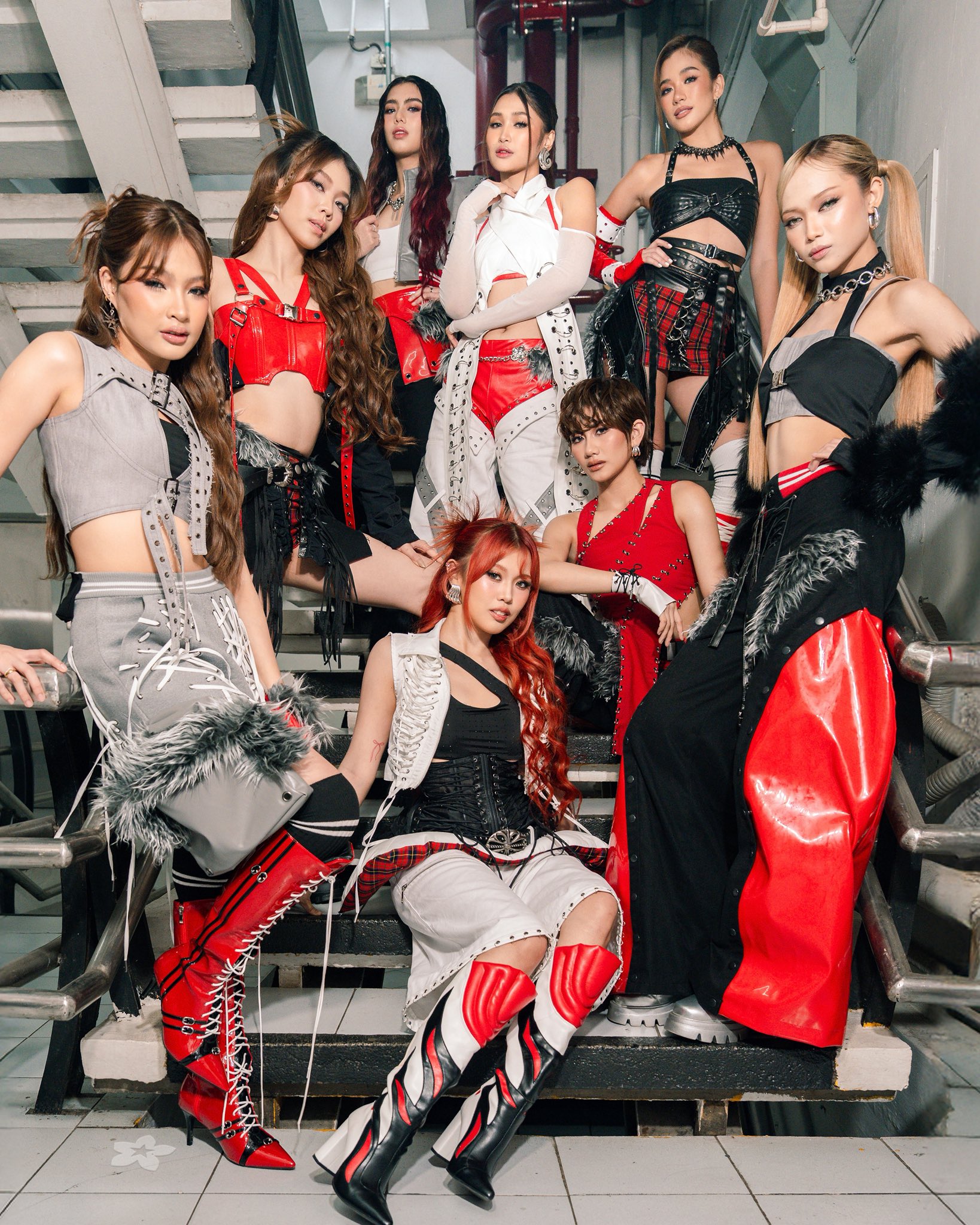 BINI members in red, black, and gray outfits